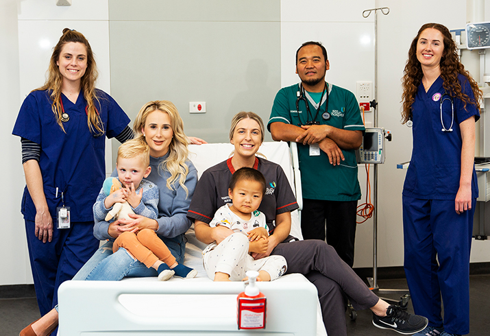 Group of health workers with a parent and two children