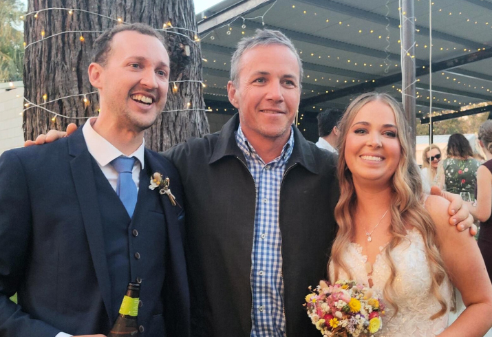 Transplant recipient Taryn pictured right at her wedding holding a bouquet of flowers alongside Transplant Physician Dr Michael Musk and husband Errol.