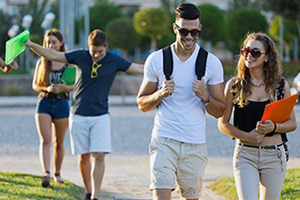 A group of young adults walking in a park.