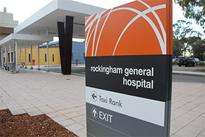 A tall sign reads of Rockingham General Hospital, with arrows pointing to a taxi rank and exit.