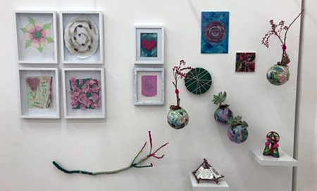 A series of small artworks hanging on a wall