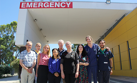group of people outside emergency department