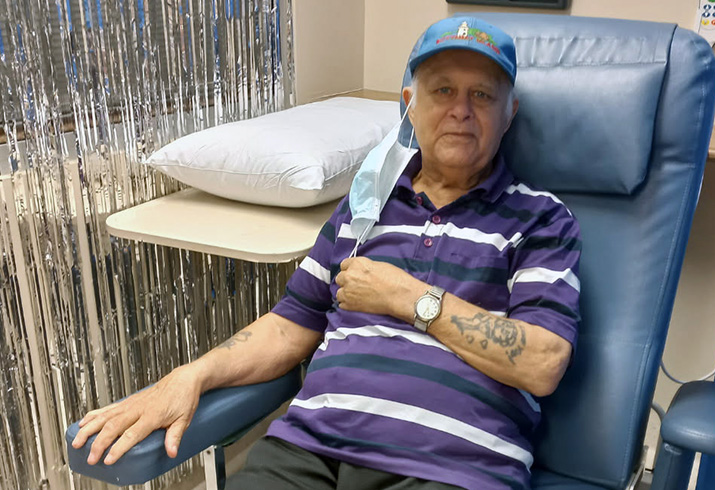 An older man reclines in a treatment chair.