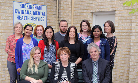 Members of the Early Episode Psychosis team stand next to a sign that reads Rockingham Kwinana Mental Health Service