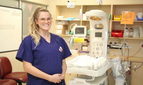 Pregnant nurse standing in Neonatal Unit